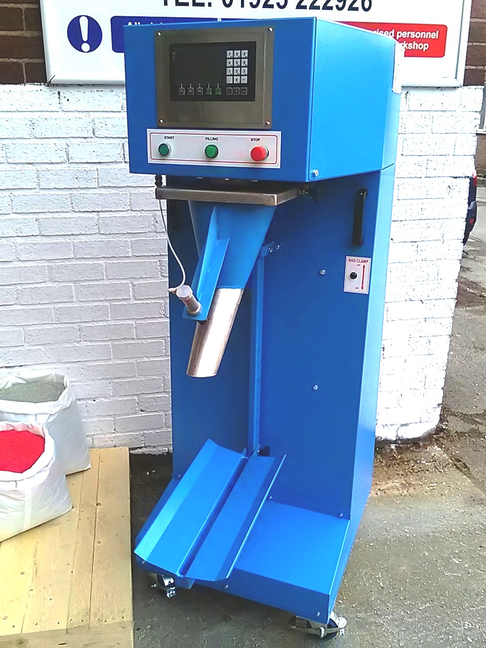 Sack fill and weigh machine